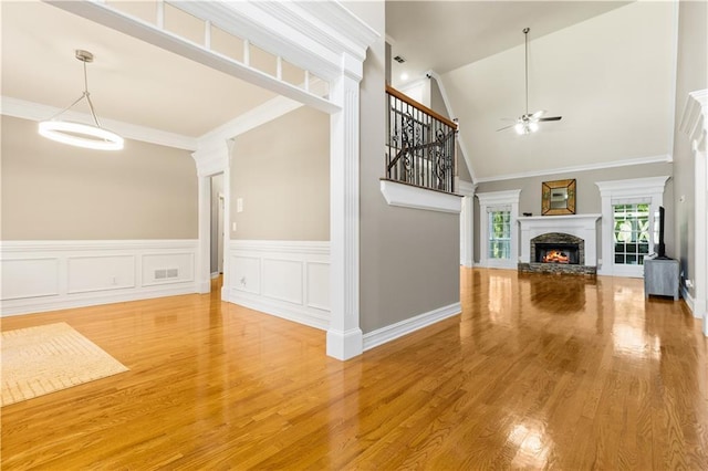 1360 Mount Mickinley Dr, Grayson, GA 30017 - unfurnished living room with ceiling fan, a fireplace, light wood-style flooring, high vaulted ceiling, and stairway