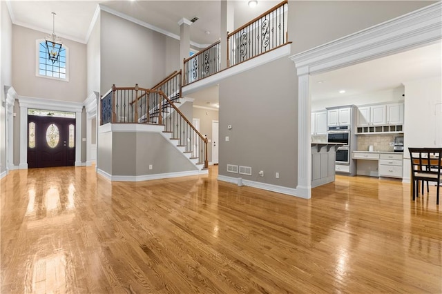 1360 Mount Mickinley Dr, Grayson, GA 30017 - entryway featuring a towering ceiling, light wood finished floors, stairs, and crown molding