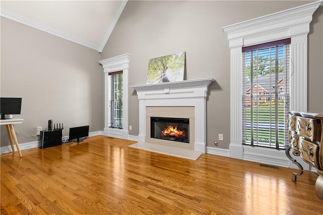 1360 Mount Mickinley Dr, Grayson, GA 30017 - unfurnished living room with crown molding, a glass covered fireplace, wood finished floors, and high vaulted ceiling