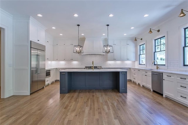 kitchen with light countertops, appliances with stainless steel finishes, and a sink