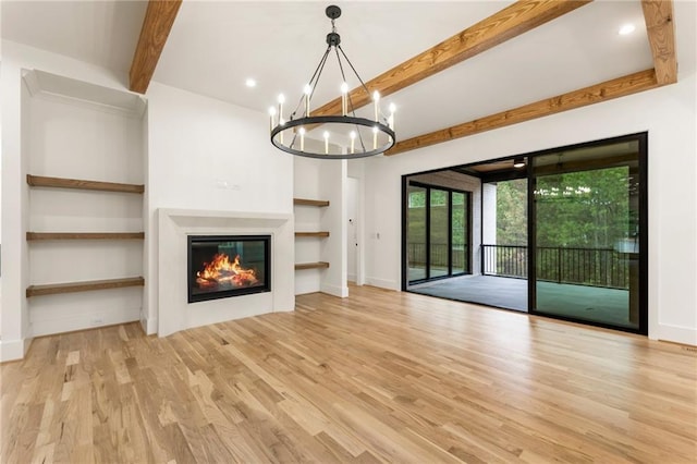 unfurnished living room with beam ceiling, recessed lighting, light wood-style flooring, a glass covered fireplace, and baseboards