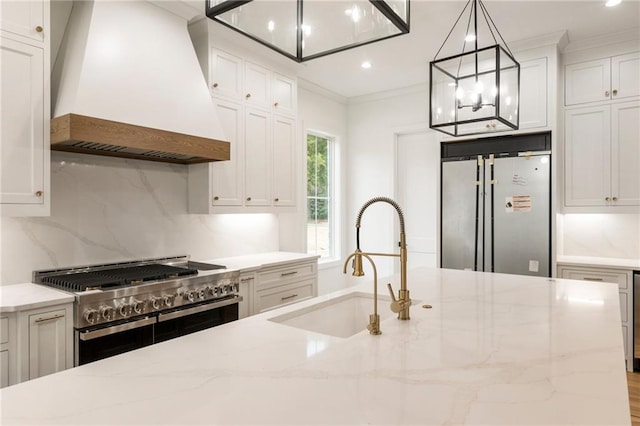 kitchen featuring stainless steel appliances, a sink, custom exhaust hood, decorative backsplash, and crown molding