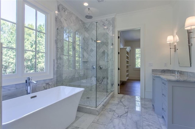 bathroom with a stall shower, ornamental molding, marble finish floor, a freestanding bath, and vanity