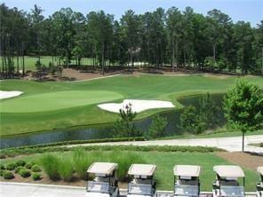 view of community with view of golf course and a water view