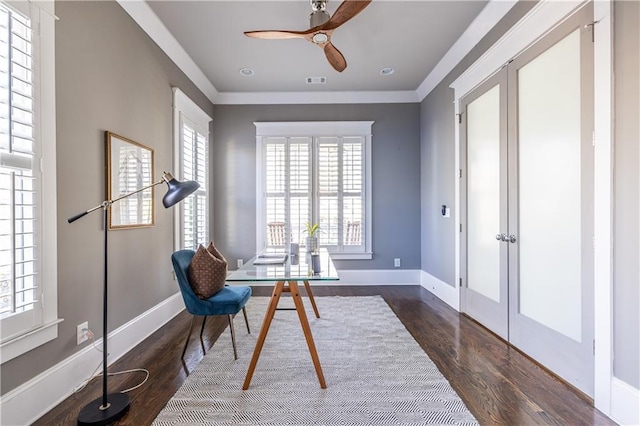 home office featuring visible vents, wood finished floors, baseboards, and ornamental molding