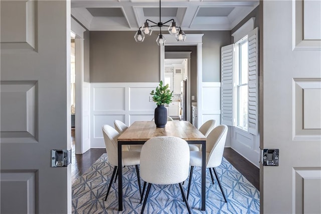 dining room with dark wood-style floors, beamed ceiling, a healthy amount of sunlight, and coffered ceiling