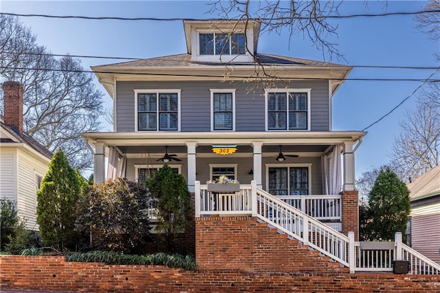 american foursquare style home featuring stairs, covered porch, and a ceiling fan