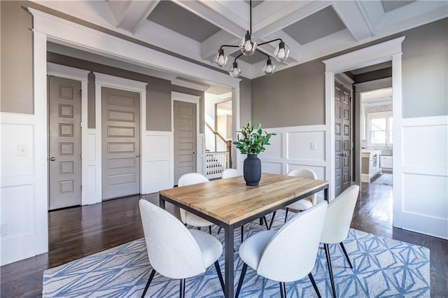 dining area with beam ceiling, stairway, and a decorative wall