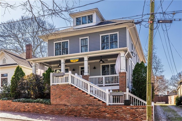 traditional style home featuring a porch, stairs, and ceiling fan