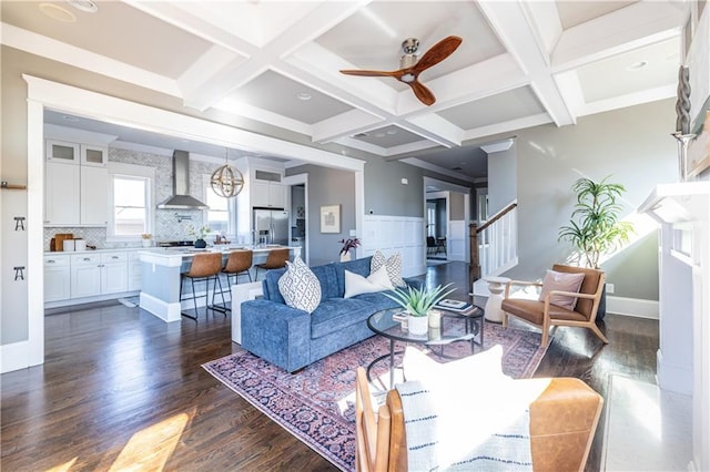 living room featuring stairway, beam ceiling, coffered ceiling, and dark wood-style flooring