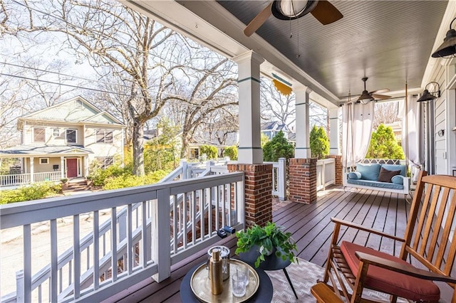 wooden terrace with a porch and ceiling fan