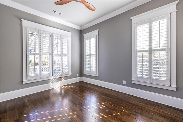 spare room featuring visible vents, ceiling fan, baseboards, and dark wood-style flooring