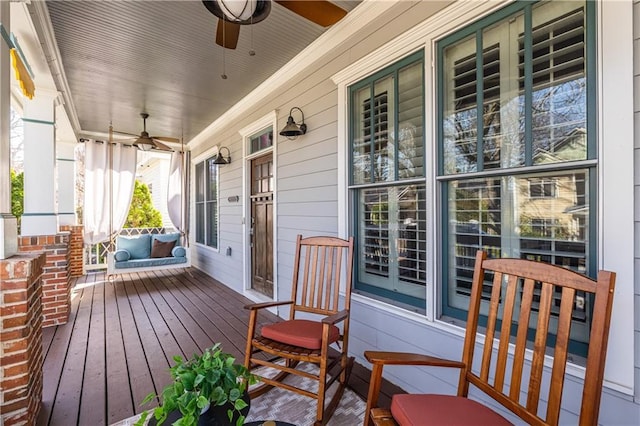 wooden deck with a porch and ceiling fan