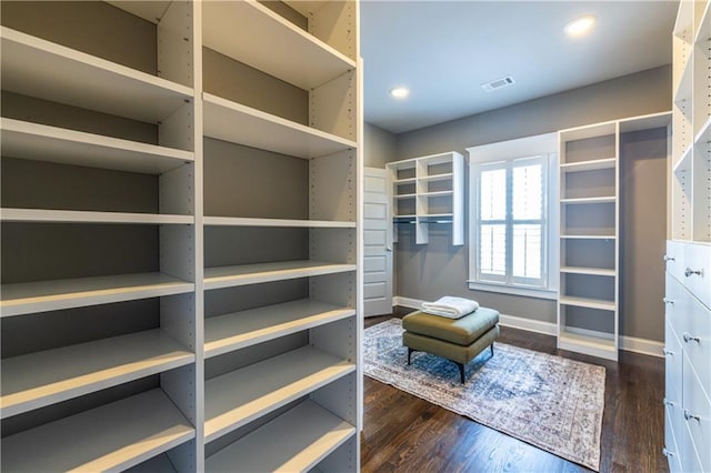 spacious closet featuring dark wood-style floors and visible vents