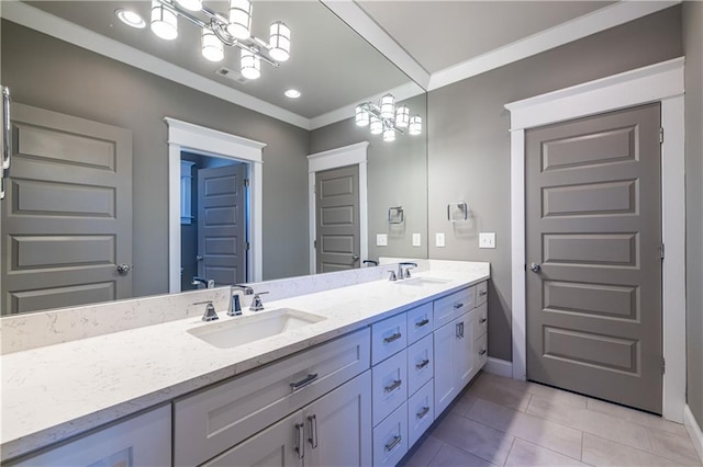 bathroom with a sink, a notable chandelier, double vanity, and tile patterned floors