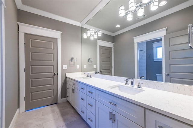 bathroom with an inviting chandelier, ornamental molding, double vanity, and a sink