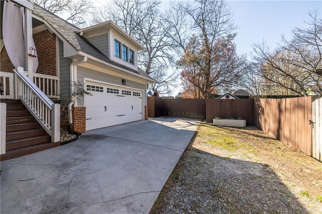 view of yard with fence and driveway