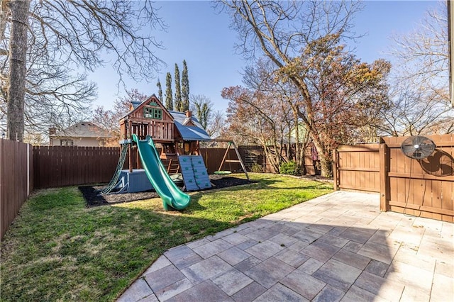 view of play area featuring a patio area, a yard, and a fenced backyard