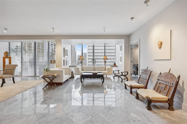 living room with baseboards, marble finish floor, and a wealth of natural light