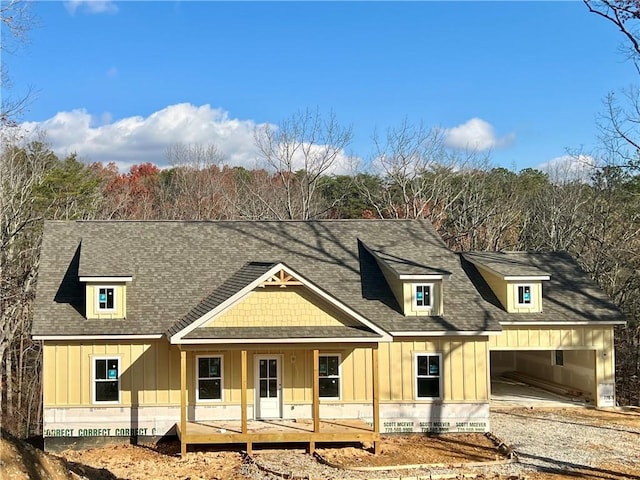 view of front of property with a porch and a garage