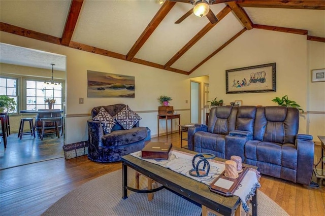 living room featuring beamed ceiling, ceiling fan with notable chandelier, hardwood / wood-style floors, and high vaulted ceiling