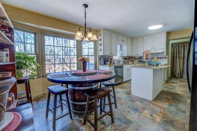 kitchen featuring tasteful backsplash, electric stovetop, stainless steel double oven, and white cabinets