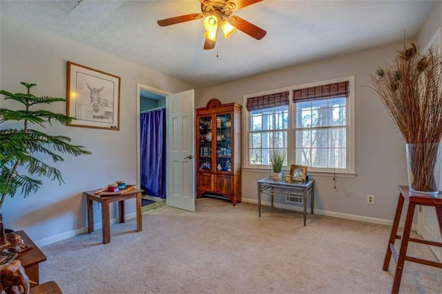 misc room featuring light colored carpet and ceiling fan