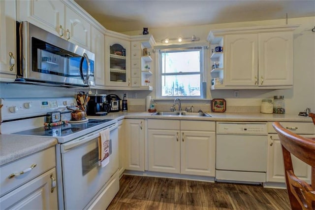 kitchen featuring sink, dark wood-type flooring, white cabinets, and white appliances