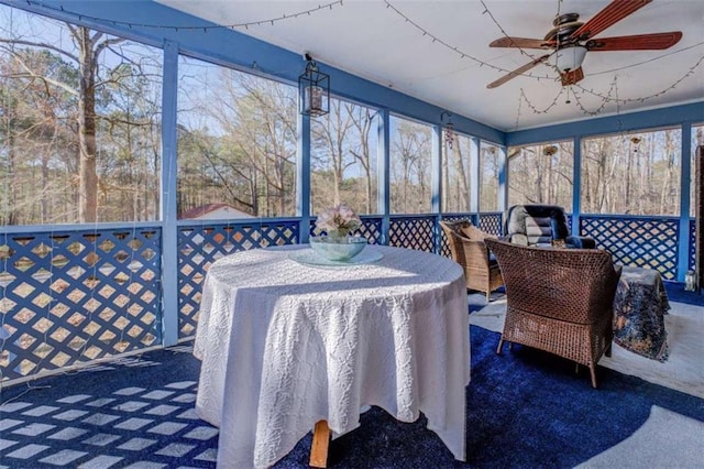 sunroom / solarium featuring ceiling fan and plenty of natural light