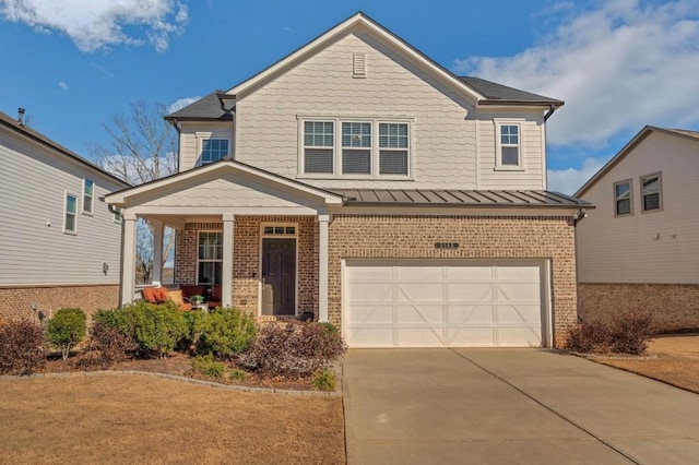 view of front of home with brick siding, concrete driveway, a standing seam roof, metal roof, and a garage