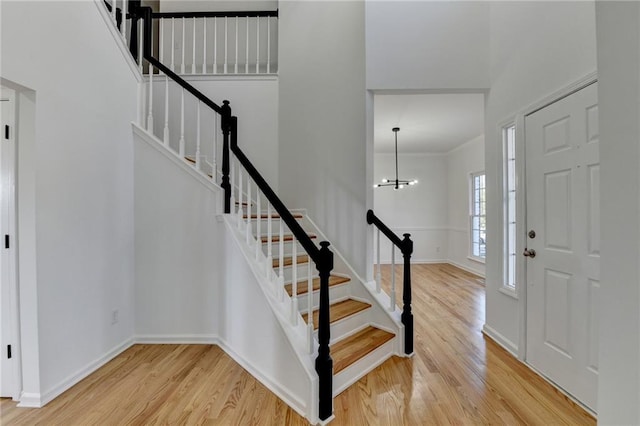 foyer entrance featuring light wood-type flooring and an inviting chandelier