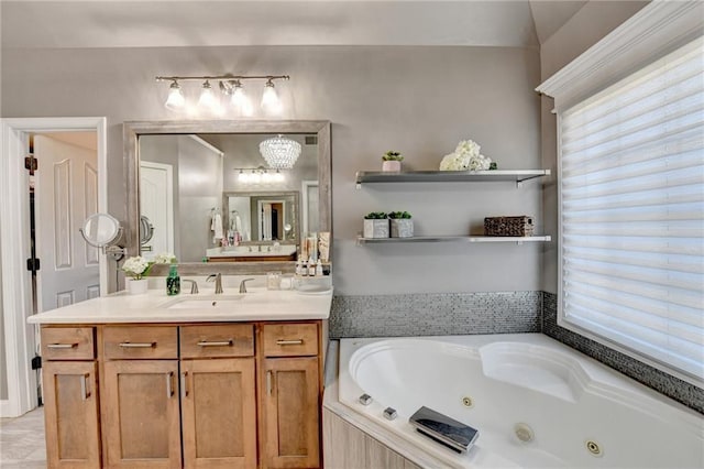 bathroom featuring a relaxing tiled tub, vanity, and a wealth of natural light