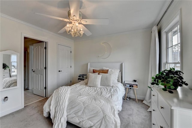 bedroom with crown molding, light carpet, and ceiling fan