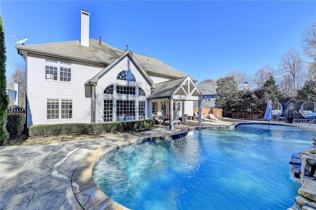 view of swimming pool featuring pool water feature and a patio area