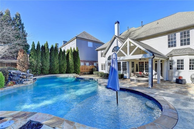 view of pool featuring pool water feature, ceiling fan, and a patio area