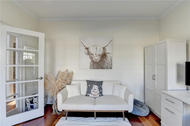 sitting room featuring hardwood / wood-style floors, ornamental molding, and french doors