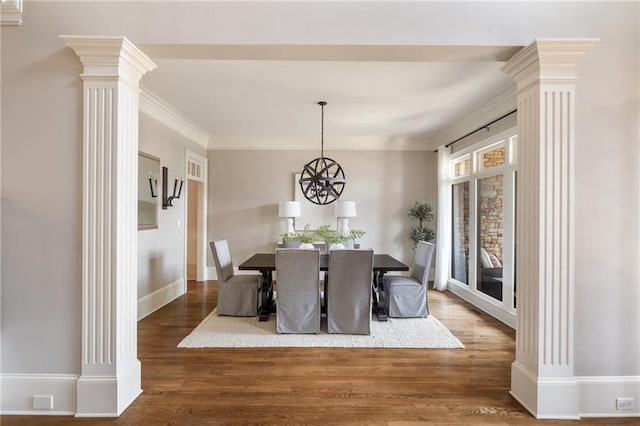 dining space with baseboards, ornamental molding, dark wood-style floors, decorative columns, and an inviting chandelier