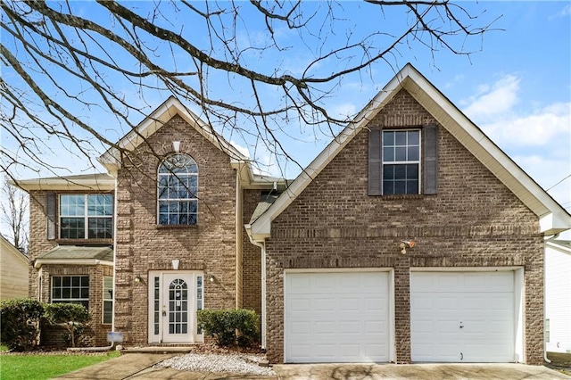 traditional-style house featuring brick siding, a garage, and driveway