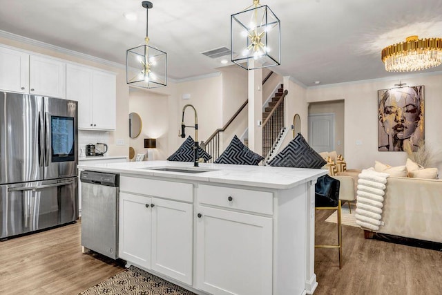 kitchen featuring pendant lighting, white cabinets, and stainless steel appliances