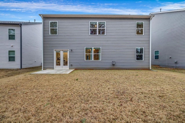 rear view of house featuring a patio and a lawn