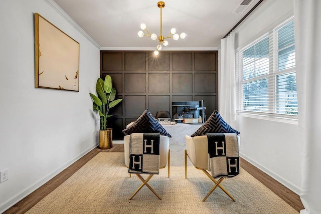 office area featuring wood-type flooring, ornamental molding, and a notable chandelier