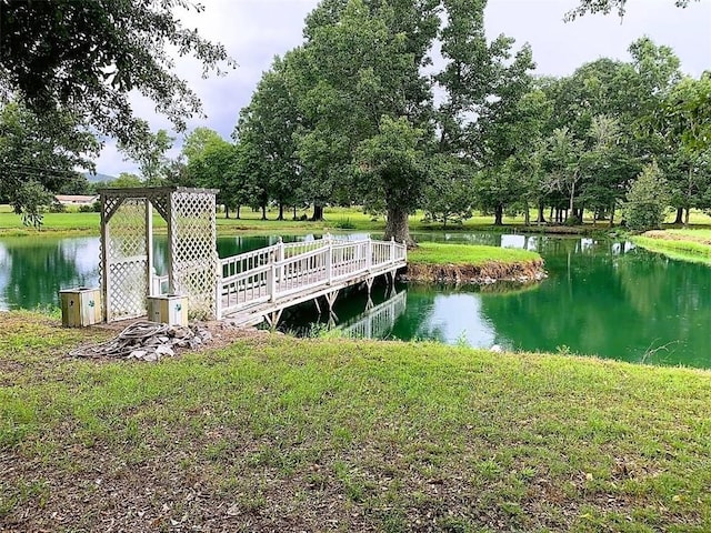 dock area featuring a water view and a yard