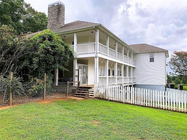 back of house with a yard and a porch