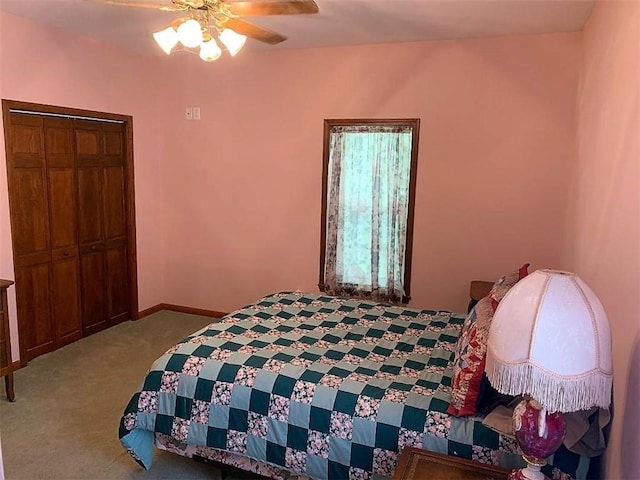 carpeted bedroom featuring ceiling fan and a closet