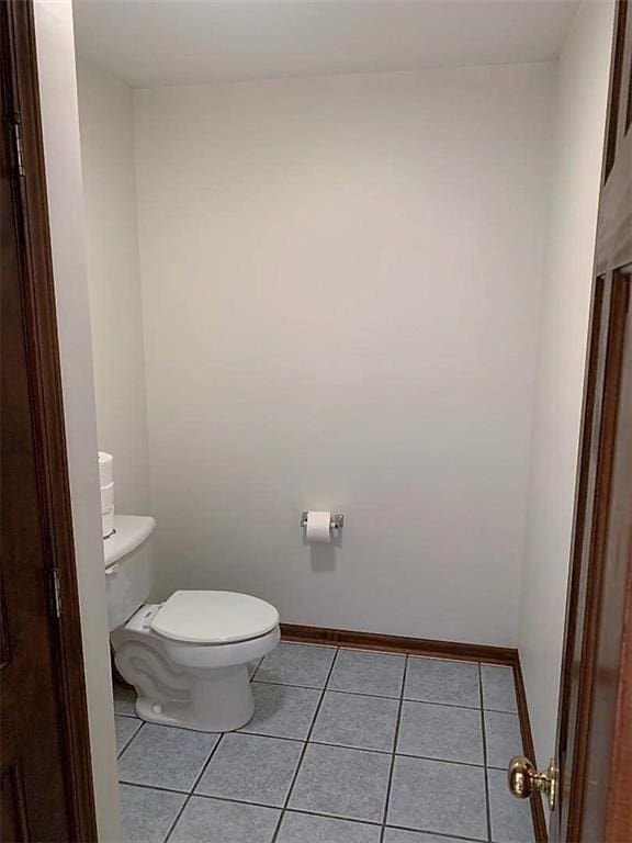 bathroom featuring toilet and tile flooring