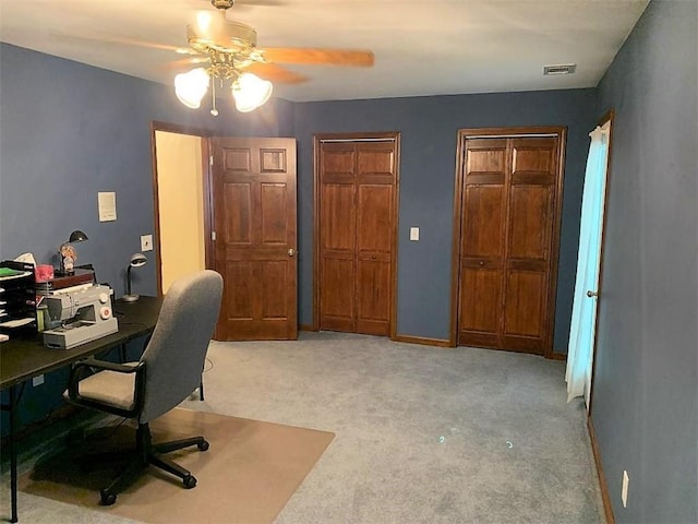 office space featuring light colored carpet and ceiling fan