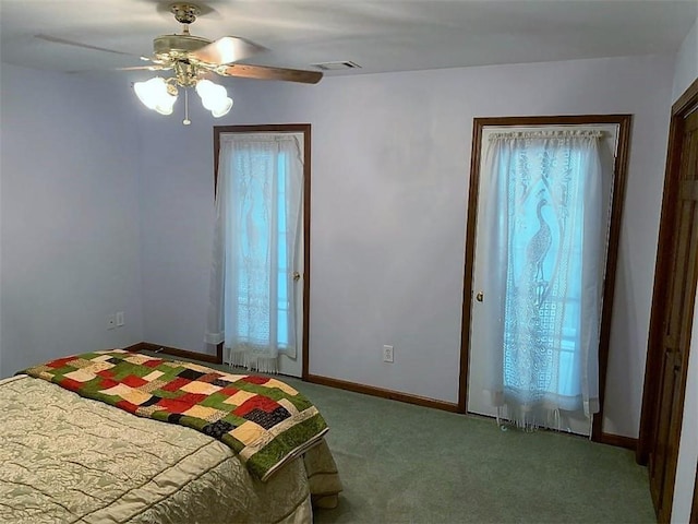 unfurnished bedroom with ceiling fan, dark carpet, and multiple windows