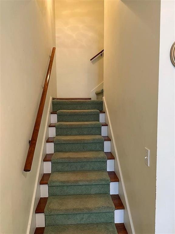 stairs featuring dark wood-type flooring