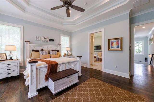 bedroom featuring visible vents, ornamental molding, a raised ceiling, and dark wood-style flooring