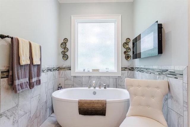 full bathroom with a freestanding bath and wainscoting